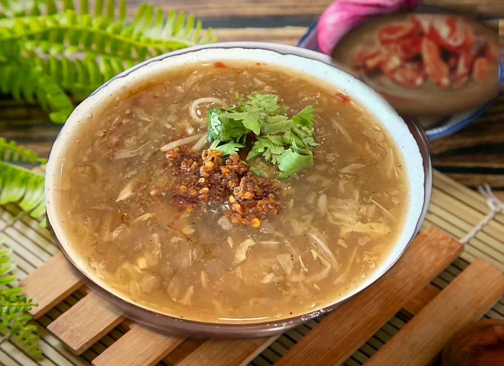 獨家口味蜀香肉羹，淋上川味辣油與香菜